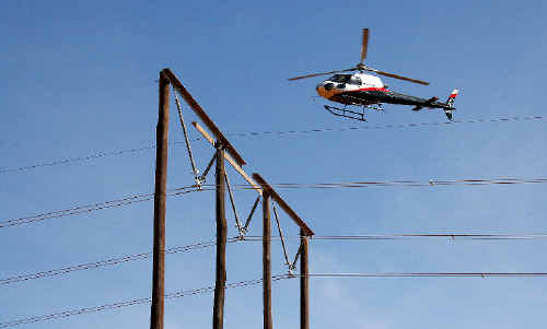 A helicopter checks a TransGrid transmission line on the Northern Rivers last November looking for any faults which might require maintenance. A helicopter checks a TransGrid transmission line on the Northern Rivers last November looking for any faults which might require maintenance.