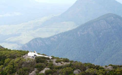A white Robinson helicopter crashed on a ridge in the Mount Barney National Park south of Warwick. A white Robinson helicopter crashed on a ridge in the Mount Barney National Park south of Warwick.