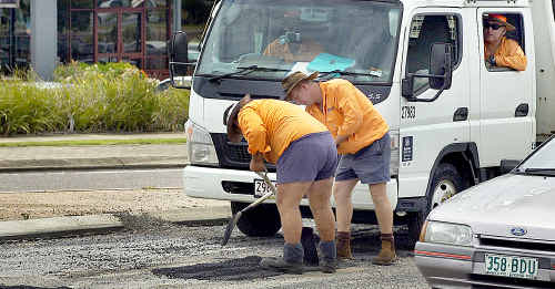 Council workers fix the potholes at the roundabout on Boat Harbour Drive and Beach Road yet again. Council workers fix the potholes at the roundabout on Boat Harbour Drive and Beach Road yet again.