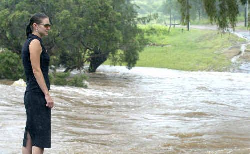 Carlee Agius inspects the height of the Dee River in Mount Morgan after residents raised fears it was getting close to some homes. Carlee Agius inspects the height of the Dee River in Mount Morgan after residents raised fears it was getting close to some homes.