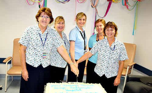 Transit Lounge nurses Jean Olsson (left), Katrina Luck and Leonie Greening (right) cut the cake with nurse manager patient flow Janeen Johnson (third left), and acting executive director of Rockhampton Hospital, Chris Mummery. Transit Lounge nurses Jean Olsson (left), Katrina Luck and Leonie Greening (right) cut the cake with nurse manager patient flow Janeen Johnson (third left), and acting executive director of Rockhampton Hospital, Chris Mummery.