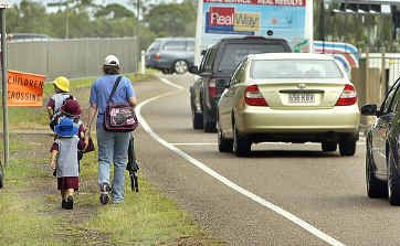 Pedestrians are forced to negotiate a section with no footpath on the Burrum Heads-Pialba Road. Pedestrians are forced to negotiate a section with no footpath on the Burrum Heads-Pialba Road.