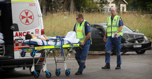 Ambulance officers take a woman to hospital after a three-car accident on Armidale Road. Ambulance officers take a woman to hospital after a three-car accident on Armidale Road.