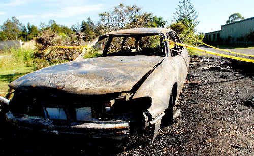 The burnt-out remains of a police car and the smashed front window of another, the result of partygoers who raged out of control after police were called to a noise complaint in Yamba in the early hours of Sunday morning. The burnt-out remains of a police car and the smashed front window of another, the result of partygoers who raged out of control after police were called to a noise complaint in Yamba in the early hours of Sunday morning.