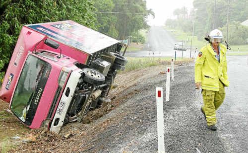 Childers Urban Fire Brigade officer John Ratcliffe attends a truck rollover at the Doolbi Fiveways, Childers.Photo: GARY HUTCHISON. BIT cra(b) 1810 Childers Urban Fire Brigade officer John Ratcliffe attends a truck rollover at the Doolbi Fiveways, Childers.Photo: GARY HUTCHISON. BIT cra(b) 1810