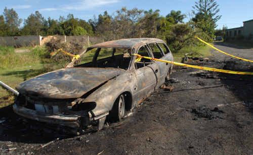 Dean Everson was shattered to see his burnt out Holden Commodore station wagon when he returned to the site of the party on Sunday. The car was one of two torched when the Yamba party turned wild.
Dean Everson was shattered to see his burnt out Holden Commodore station wagon when he returned to the site of the party on Sunday. The car was one of two torched when the Yamba party turned wild.