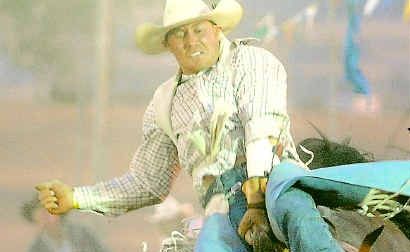 Cowboy Fred Osman hangs on during a recent rodeo competition. Cowboy Fred Osman hangs on during a recent rodeo competition.