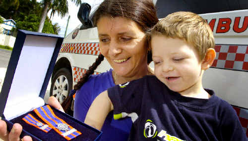 Bravery award winner Sandra Lawler receives her medal with son Ben Leadbeatter (3). Ms Lawler trekked through swollen river crossings and up cliffs with her two sons to get baby Samuel, not pictured, to hospital after he developed breathing problems. Bravery award winner Sandra Lawler receives her medal with son Ben Leadbeatter (3). Ms Lawler trekked through swollen river crossings and up cliffs with her two sons to get baby Samuel, not pictured, to hospital after he developed breathing problems.