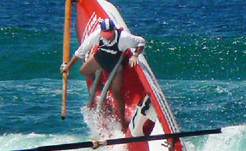 Evans Head-Casino surf boat sweep Peter Hickey commits to the ride while stroke John Lisetto of Rock Valley tumbles into the surf during the boat races at Tugun on Saturday. Evans Head-Casino surf boat sweep Peter Hickey commits to the ride while stroke John Lisetto of Rock Valley tumbles into the surf during the boat races at Tugun on Saturday.