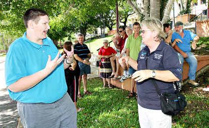Using sign language to communicate at a social gathering for the hearing impaired are Jason Roberts and Karon Robertson . Using sign language to communicate at a social gathering for the hearing impaired are Jason Roberts and Karon Robertson .
