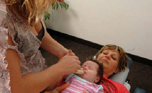 TREATING BABY: Chiropractor Sarah Winchester treats a newborn child. TREATING BABY: Chiropractor Sarah Winchester treats a newborn child.