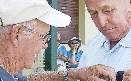 President of Bundaberg Seniors Tennis Club, Alan Searle, presents Lloyd Pitt with his life membership badge. President of Bundaberg Seniors Tennis Club, Alan Searle, presents Lloyd Pitt with his life membership badge.