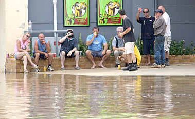 Patrons at the Corones Hotel in Wills Street, Charleville, enjoy a beer yesterday as they wait for the second wave of floodwater to arrive. Patrons at the Corones Hotel in Wills Street, Charleville, enjoy a beer yesterday as they wait for the second wave of floodwater to arrive.