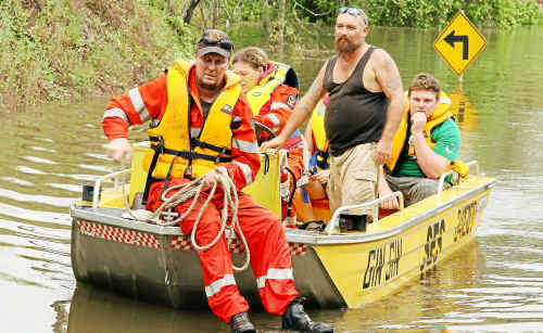 State Emergency Service volunteers Darren Coombes and Kellie Bolstad ferrying John Dickson, Phillip Lindsay and others across the flooded Perry River yesterday. State Emergency Service volunteers Darren Coombes and Kellie Bolstad ferrying John Dickson, Phillip Lindsay and others across the flooded Perry River yesterday.