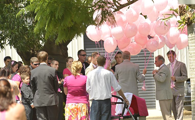 Pink balloons are given to Trinity Bates family at her funeral today, hundreds of Bundaberg community members attended. Pink balloons are given to Trinity Bates family at her funeral today, hundreds of Bundaberg community members attended.