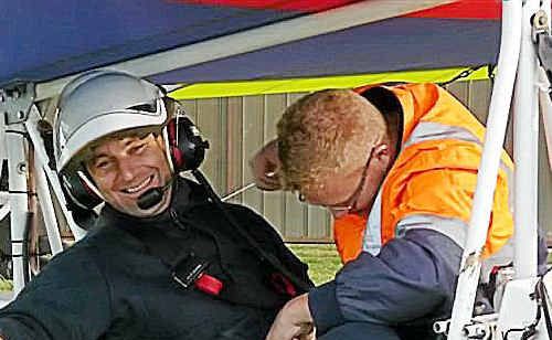 Nigel Gambasin from the Sunshine Coast being strapped into a Drifter aircraft by his pilot James Bange. Nigel Gambasin from the Sunshine Coast being strapped into a Drifter aircraft by his pilot James Bange.