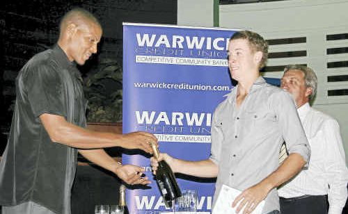 Guest speaker Michael McDaniel (left) presents a trophy and a bottle of wine to December sports star winner Donald Miller and Warwick Loan Centre manager Barry McKinnon. A similar presentation was made to each monthly winner. Guest speaker Michael McDaniel (left) presents a trophy and a bottle of wine to December sports star winner Donald Miller and Warwick Loan Centre manager Barry McKinnon. A similar presentation was made to each monthly winner.