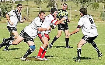 Killarney Cutters hooker Jamie Watts wrapped up by Texas Terriers Dave Williams with Kerrod Rigny covering the tackle. Killarney Cutters hooker Jamie Watts wrapped up by Texas Terriers Dave Williams with Kerrod Rigny covering the tackle.