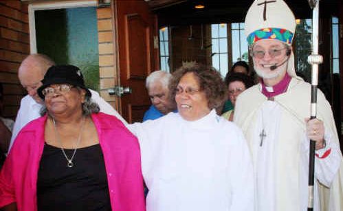 The Reverend Lenore Parker, centre, the first indigenous ordained person in the 146-year history of the Anglican Diocese of Grafton, is presented to the people by her Bishop, the Rt Rev Keith Slater. Congratulating her is Yaegl elder and aunt Lillian Williams. The Reverend Lenore Parker, centre, the first indigenous ordained person in the 146-year history of the Anglican Diocese of Grafton, is presented to the people by her Bishop, the Rt Rev Keith Slater. Congratulating her is Yaegl elder and aunt Lillian Williams.
