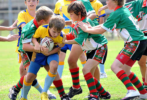 Lachlan Smith works hard to shrug off Hervey Bay defenders. Lachlan Smith works hard to shrug off Hervey Bay defenders.