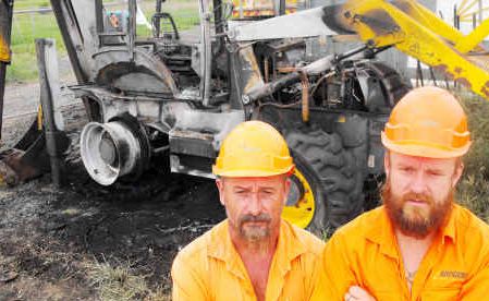 Nightmare job: Arogen site foreman Dave Pemberton (left) and company co-owner Tony O’Meley in Lismore yesterday with the backhoe destroyed by a fire which Mr O’Meley says was deliberately lit. Nightmare job: Arogen site foreman Dave Pemberton (left) and company co-owner Tony O’Meley in Lismore yesterday with the backhoe destroyed by a fire which Mr O’Meley says was deliberately lit.