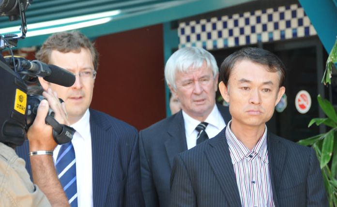 Shen Neng 1 master Wang Jichang (right) leaves Gladstone Police Station with barrister Tony Glynn and defence solicitor Matthew Hockaday (left) Shen Neng 1 master Wang Jichang (right) leaves Gladstone Police Station with barrister Tony Glynn and defence solicitor Matthew Hockaday (left)