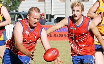 Redback Clinton McErvale gains the ball while Andrew Bardsley shepherds opposition players. Redback Clinton McErvale gains the ball while Andrew Bardsley shepherds opposition players.