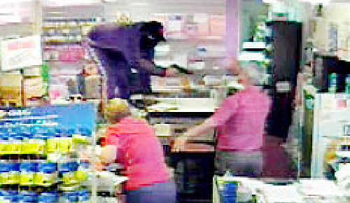 Fish points a gun during the Amberley Post Office raid in September 2009. Fish points a gun during the Amberley Post Office raid in September 2009.