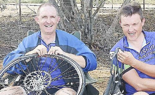 John Eder and Lorin Nicholson change tyres outside Hay yesterday during the Blind Courage Ride. John Eder and Lorin Nicholson change tyres outside Hay yesterday during the Blind Courage Ride.