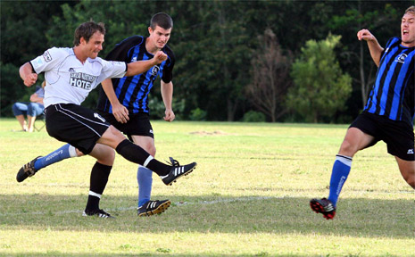 Byron Bay’s Jordy Campbell blasts a shot towards goal, with Bangalow’s Dustin Rudgley giving him close attention. Photo: Gregory Meek. Byron Bay’s Jordy Campbell blasts a shot towards goal, with Bangalow’s Dustin Rudgley giving him close attention. Photo: Gregory Meek.