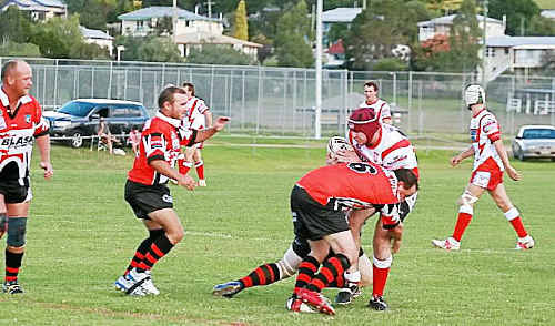 Killarney player John Bunch is tackled by Matt Gainey. Killarney player John Bunch is tackled by Matt Gainey.
