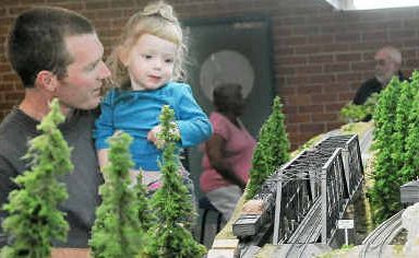 Signals go: Engineer Ian Phemister and his daughter, Abbi, with the mobile model train display at Coffs Show. Signals go: Engineer Ian Phemister and his daughter, Abbi, with the mobile model train display at Coffs Show.