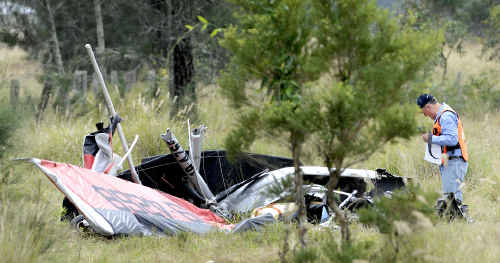 Crash probed: An investigator from the Recreational Aviation Association inspects the wreckage of the ultralight at the crash site near Tatham on Saturday. Crash probed: An investigator from the Recreational Aviation Association inspects the wreckage of the ultralight at the crash site near Tatham on Saturday.