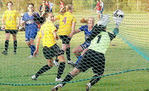Corindi-Red Rock keeper Jess Seymour parries a shot on goal away against Woolgoolga. Corindi-Red Rock keeper Jess Seymour parries a shot on goal away against Woolgoolga.