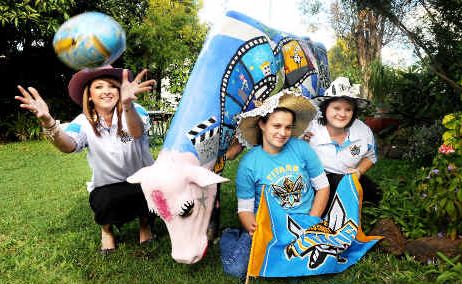 Beef Week Queen entrants (from left) Kasey-Lee Flack, Claire Carey and Melissa Gray help to promote Beef Week using Titans merchandise and the colourful Beef Week Picasso cow. Beef Week Queen entrants (from left) Kasey-Lee Flack, Claire Carey and Melissa Gray help to promote Beef Week using Titans merchandise and the colourful Beef Week Picasso cow.