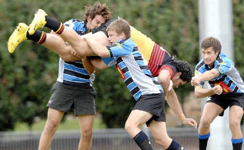 Local hospitality: Far North Coast players give Central Coast opponent Mataala Higgins a warm welcome to Lismore in the NSW Country junior rugby union championship at Oakes Oval on Saturday. Local hospitality: Far North Coast players give Central Coast opponent Mataala Higgins a warm welcome to Lismore in the NSW Country junior rugby union championship at Oakes Oval on Saturday.