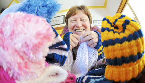 Close-knit community: Kerry Wallis co-ordinates the Busy Hands, Warm Hearts concept and is seen here with some of their handiwork. Close-knit community: Kerry Wallis co-ordinates the Busy Hands, Warm Hearts concept and is seen here with some of their handiwork.