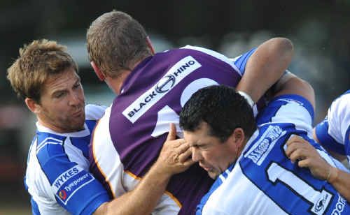 A Rhino player is brought to a standstill by Ghosts defenders. A Rhino player is brought to a standstill by Ghosts defenders.