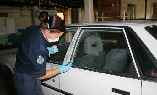 Scenes of crime officer Constable Justine Hartley dusts elderly couple Elizabeth and Bill Steele’s car for finger prints yesterday. Scenes of crime officer Constable Justine Hartley dusts elderly couple Elizabeth and Bill Steele’s car for finger prints yesterday.