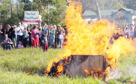 A mock Woolworths is torched at an early protest at Mullumbimby. A mock Woolworths is torched at an early protest at Mullumbimby.