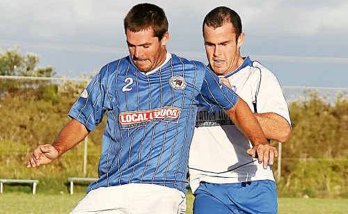Woolgoolga’s Lindsay Athorn keeps the ball from the Storm’s Luke Venn. Woolgoolga’s Lindsay Athorn keeps the ball from the Storm’s Luke Venn.
