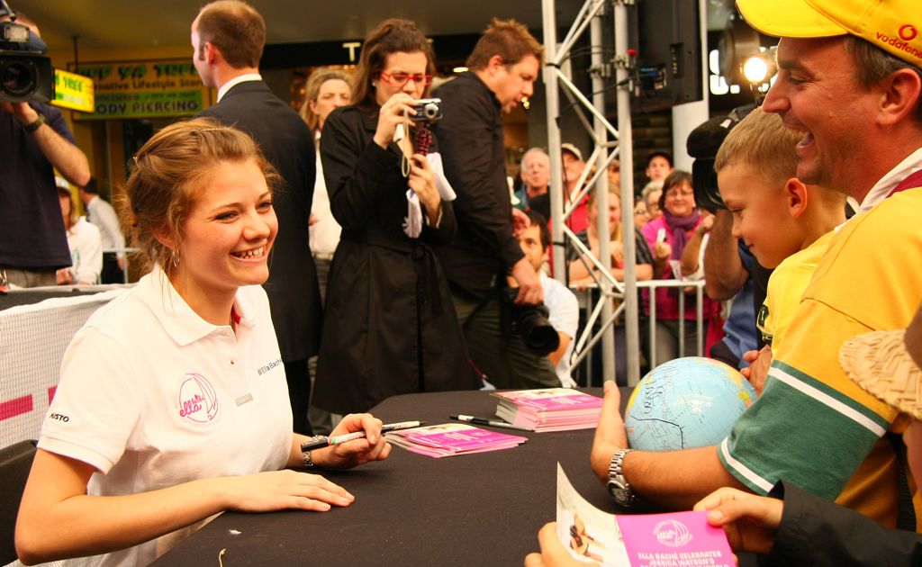 Jessica Watson signs a globe for a happy family. Jessica Watson signs a globe for a happy family.