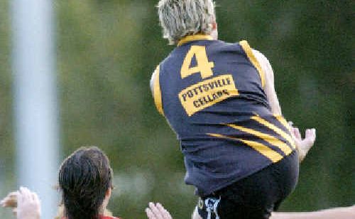 Tweed Coast’s Jason Bolt (4) soars above Lismore defenders Angus Legoe (25) and Phil Tsourlinis (8) in their Summerland AFL clash at Mortimer Oval in Lismore on Saturday. Tweed Coast’s Jason Bolt (4) soars above Lismore defenders Angus Legoe (25) and Phil Tsourlinis (8) in their Summerland AFL clash at Mortimer Oval in Lismore on Saturday.