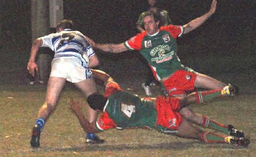 Tannum Seagulls players try hard to bring down Brothers’ Tommy Robertson during the A-grade match at Calliope on Saturday night. Tannum Seagulls players try hard to bring down Brothers’ Tommy Robertson during the A-grade match at Calliope on Saturday night.