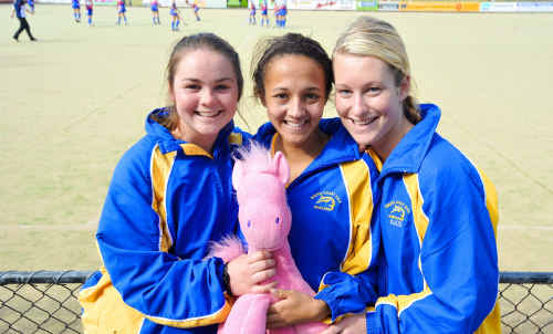 South Coast visitors Kalindi Commerford, Kizziah Plumb and Kate McKinley huddle up with their team mascot yesterday. South Coast visitors Kalindi Commerford, Kizziah Plumb and Kate McKinley huddle up with their team mascot yesterday.