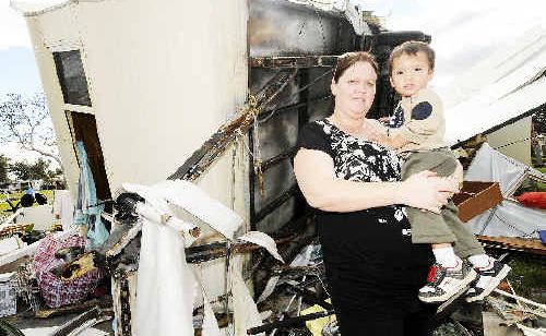Alison Kaihhau and her 22-month-old son Tane of Kyogle with demolished caravan owned by Alison’s parents, also of Kyogle. Alison Kaihhau and her 22-month-old son Tane of Kyogle with demolished caravan owned by Alison’s parents, also of Kyogle.