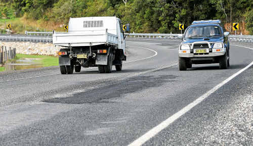 JUST one week after being completed the multi-million Marx Hill upgrade on Waterfall Way has failed its first test. Last week’s rain created some huge potholes in the surface of the roadway which in turn prompted a number of emergency patch-up jobs. The road took five months to build at a cost of $5.3 million but questions must now be asked about why such an expensive piece of infrastructure couldn’t cope with around 150 millimetres of rain over three days. The road was completely funded by the State Government and built by the Roads and Traffic Authority’s Road and Fleet Services division. It last week claimed the project which involved the laying of 15,000 cubic metres of road base was completed ahead of schedule and under budget. JUST one week after being completed the multi-million Marx Hill upgrade on Waterfall Way has failed its first test. Last week’s rain created some huge potholes in the surface of the roadway which in turn prompted a number of emergency patch-up jobs. The road took five months to build at a cost of $5.3 million but questions must now be asked about why such an expensive piece of infrastructure couldn’t cope with around 150 millimetres of rain over three days. The road was completely funded by the State Government and built by the Roads and Traffic Authority’s Road and Fleet Services division. It last week claimed the project which involved the laying of 15,000 cubic metres of road base was completed ahead of schedule and under budget.