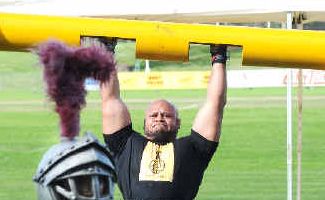 He ain't heavy: Australian strongest man, Derek Boyle, lifts a 125kg log at Oakes Oval while competing in the national strongman titles on Saturday. The strongman mascot ‘Robert the Bruce’ is in the foreground. He ain't heavy: Australian strongest man, Derek Boyle, lifts a 125kg log at Oakes Oval while competing in the national strongman titles on Saturday. The strongman mascot ‘Robert the Bruce’ is in the foreground.
