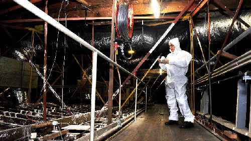 Lismore City Hall operations manager Carl Johnson dresses in an asbestos suit before working in the roof of the Lismore City Hall. However, pleas to the Lismore City Council to fix the asbestos problem fell on deaf ears when remediation costs were cut from the council’s budget. Lismore City Hall operations manager Carl Johnson dresses in an asbestos suit before working in the roof of the Lismore City Hall. However, pleas to the Lismore City Council to fix the asbestos problem fell on deaf ears when remediation costs were cut from the council’s budget.