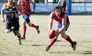 Brendan Iles takes the ball for the Warwick Redbacks. Brendan Iles takes the ball for the Warwick Redbacks.